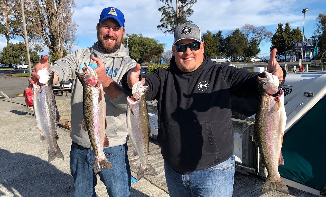Two happy customers with four trout caught with White Striker Charters